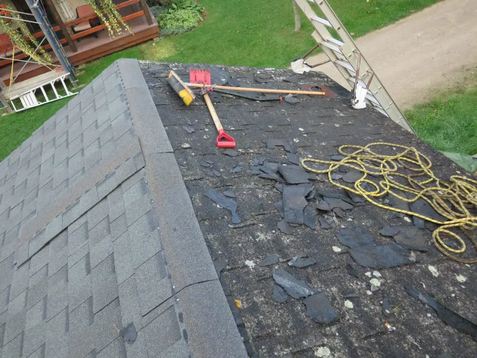 Damaged roof with tools and rope for repair