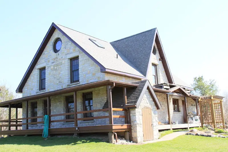 Stone farmhouse with wooden porch
