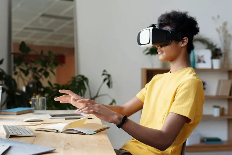 Person using virtual reality headset at desk.
