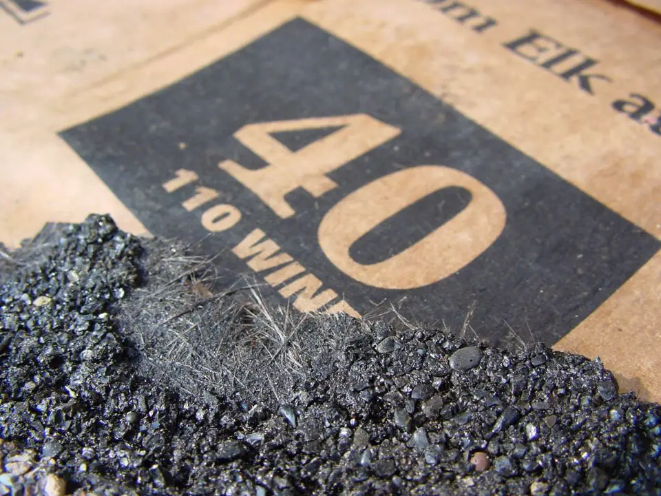 This torn fiberglass shingle shows the internal glass fibers that make for sure long life and heat resistance. So-called “organic” asphalt shingles have heavy paper felt instead of glass fibers.