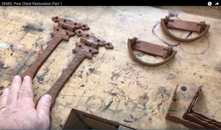 Rusty hinges and handles on workbench.