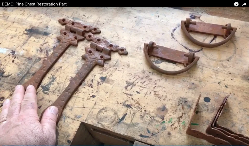 Rusty hinges and handles on workbench.