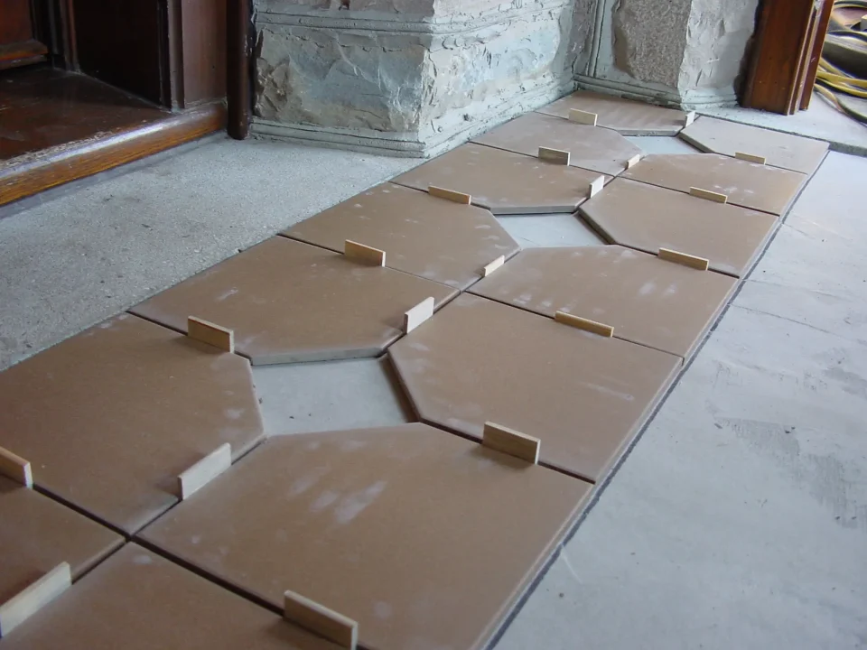 Brown tiles aligned with spacers on floor