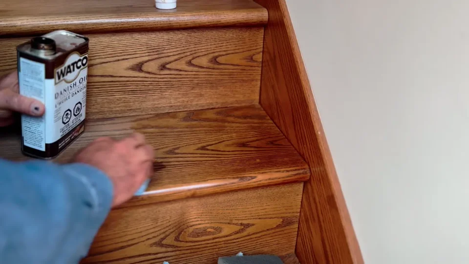 Applying Danish oil to wooden stairs