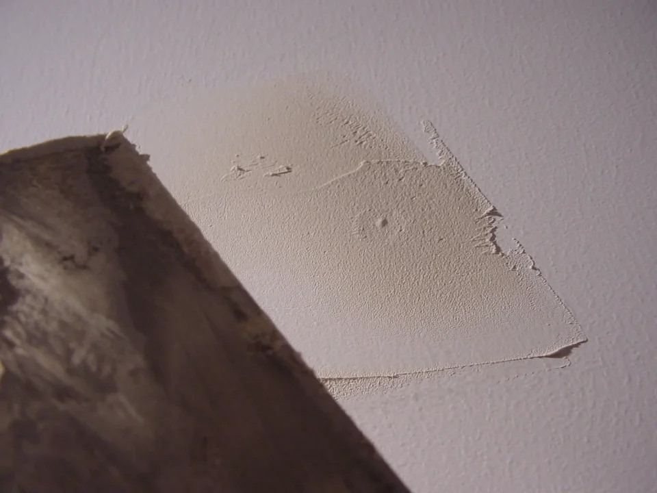 Applying drywall mud with a taping knife