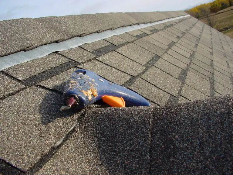 Glue gun on asphalt shingle roof