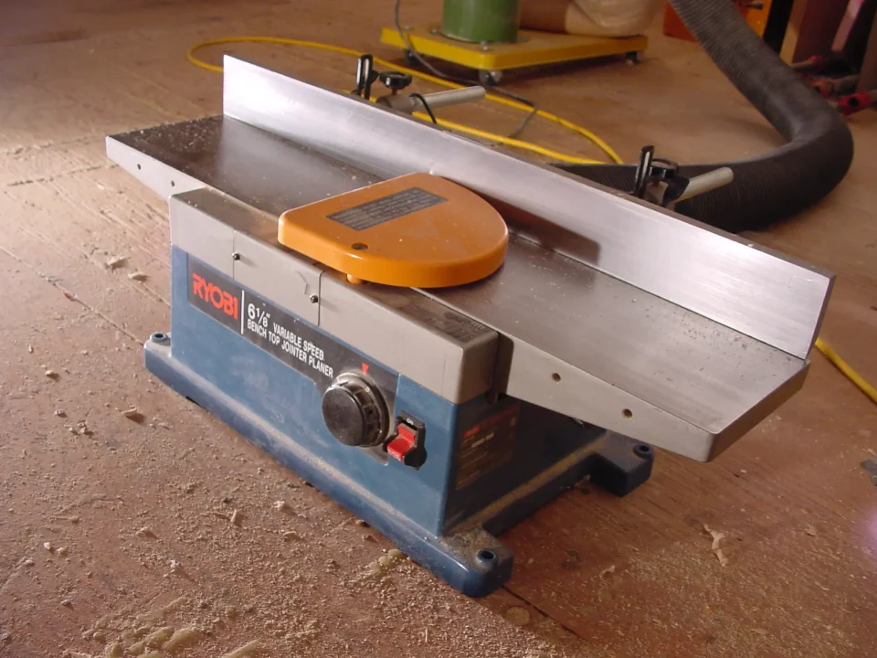 Ryobi benchtop jointer planer on a workshop floor.