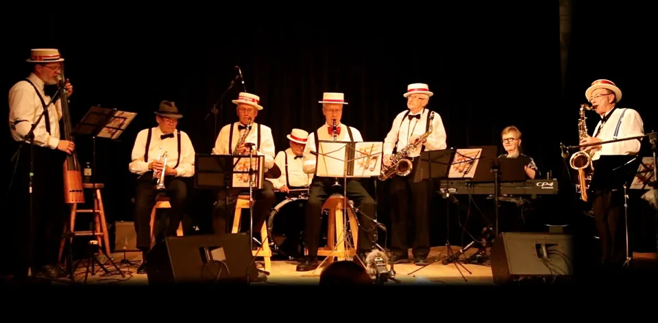 Jazz band performing on stage with instruments.