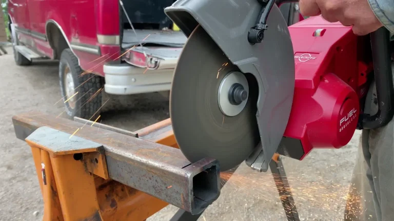 Chop saw cutting metal, sparks flying.