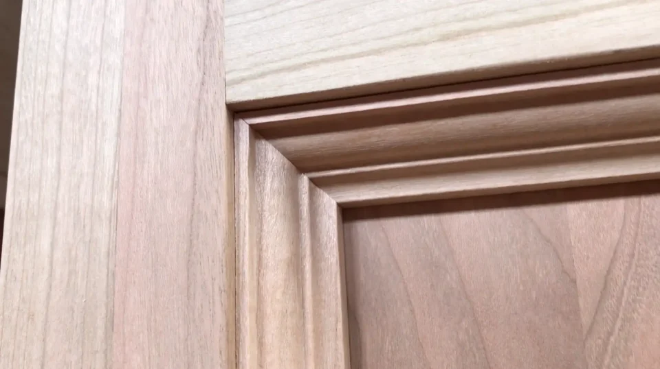 Natural wood panel with grooves and texture.