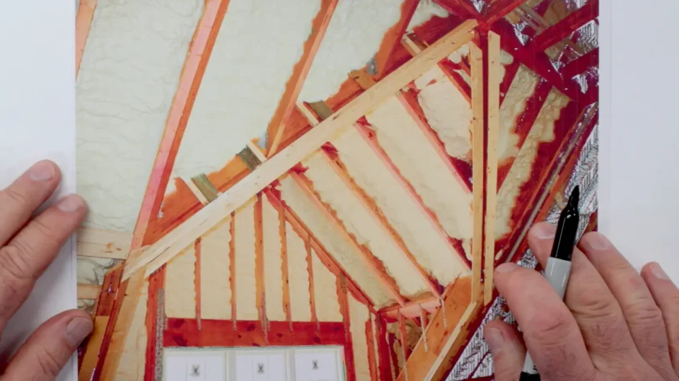 Hands holding architectural sketch of insulated attic.