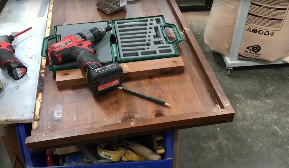 Tools on wooden workbench in a workshop.