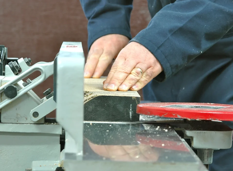 Woodworker using table saw for cutting wood