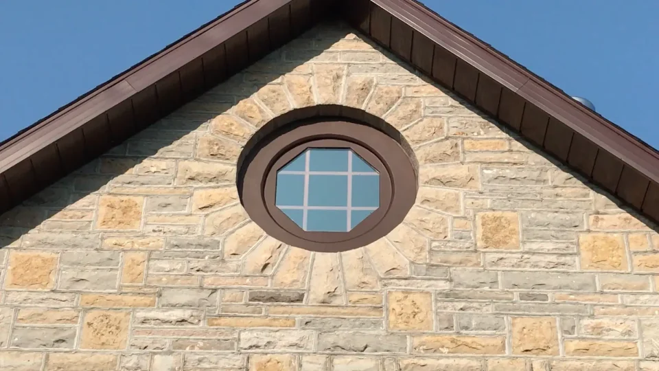 Circular window on brick building facade