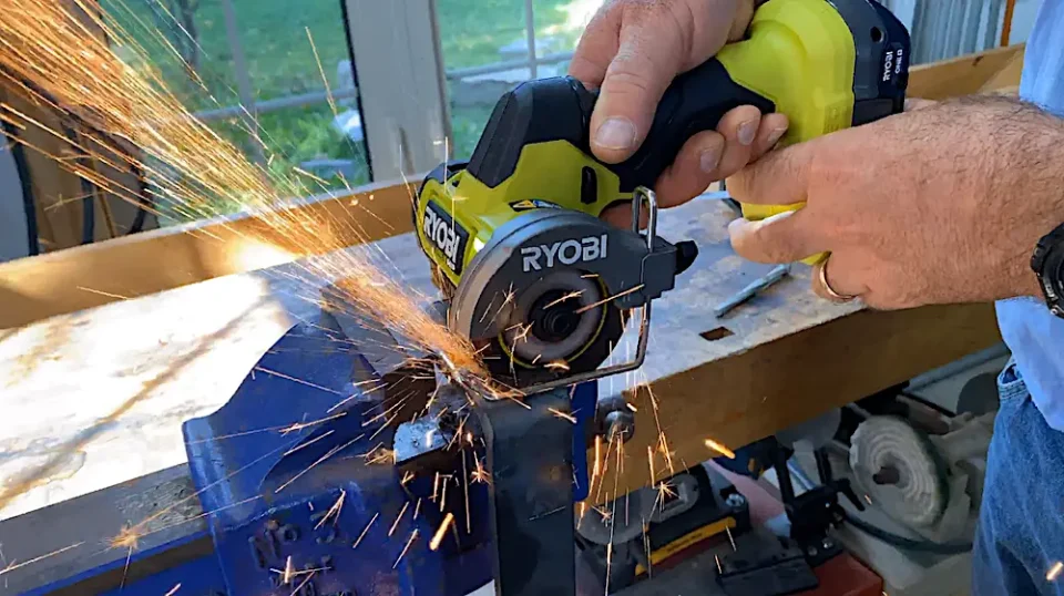 Cutting metal with Ryobi power tool, sparks flying
