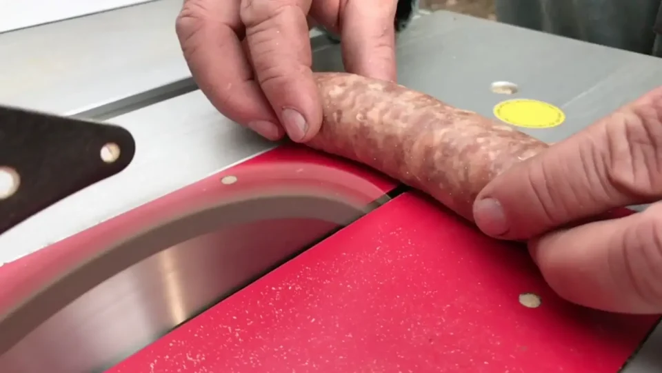 Testing sausage on table saw for safety demonstration.