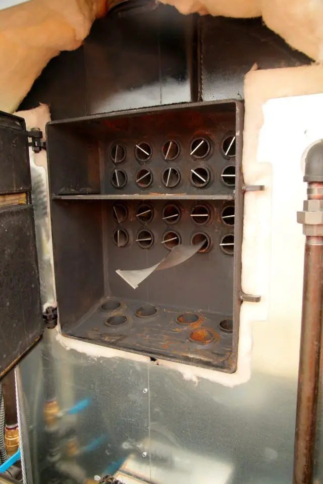 This open door reveals the fire tube heat exchanger in the first of two outdoor boilers I’ve used at my place. This design of heat exchanger was first used with steam locomotives in the 1800s.