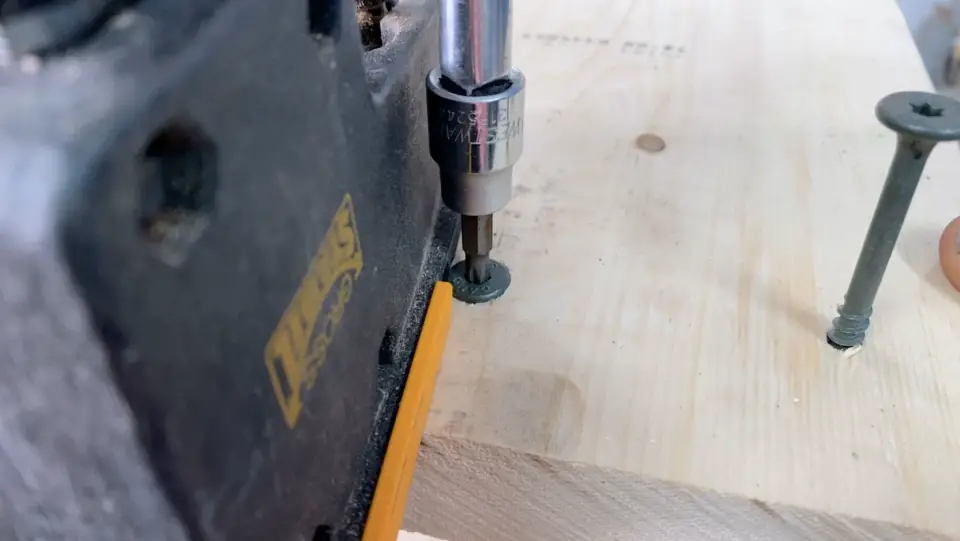 Here I am using construction screws to fasten the top to the footstool project.