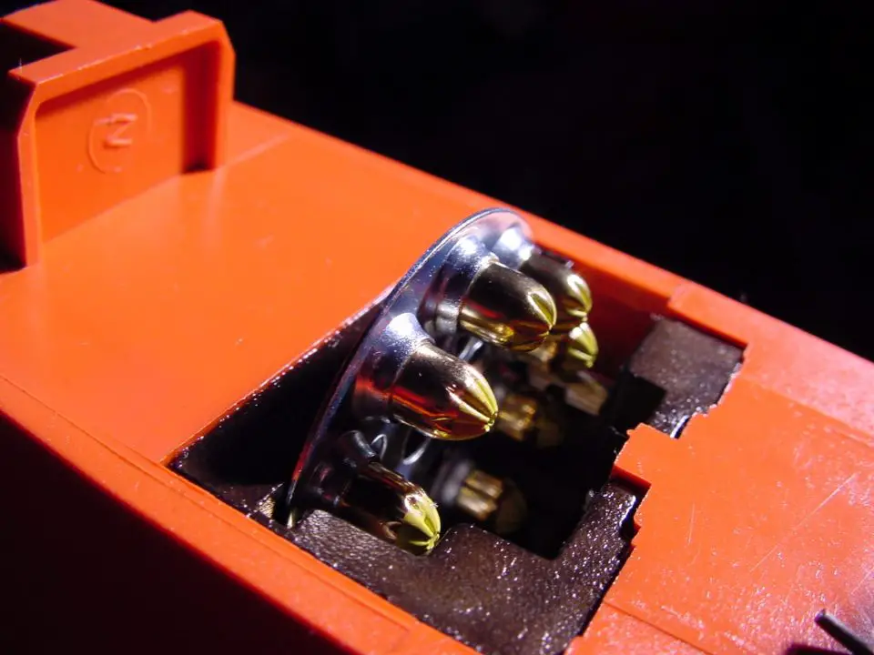This shows the top of a semi-automatic PAT, with a disk of charge cartridges loaded in. A fresh cartridge advances with each pull of the trigger.
