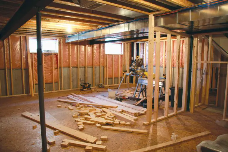 Basement renovation with exposed wooden framing.