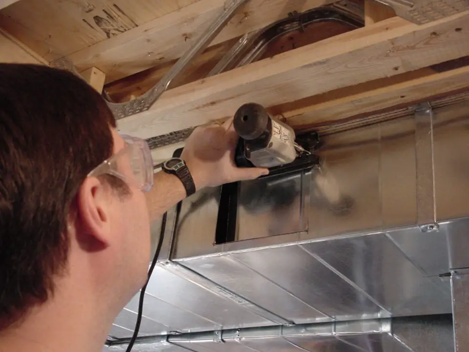 Cutting into a duct like this is an important part of configuring a forced-air heating system so it can serve a basement space comfortably. The variable speed jigsaw that’s doing the work has been fitted with a fine-tooth metal-cutting blade. Don’t try this job with a regular jigsaw blade for wood.