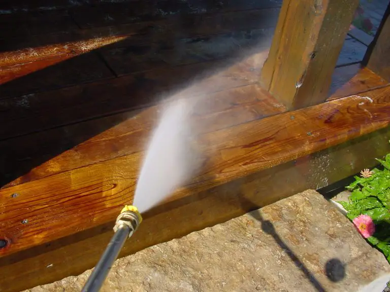Pressure washing wooden deck for cleanliness