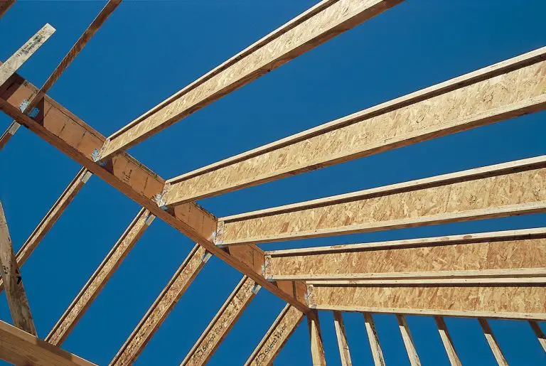 Wooden roof trusses under clear blue sky construction