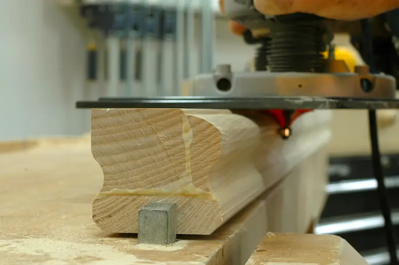 The first of two router passes that form the curved top edge of a hand rail.