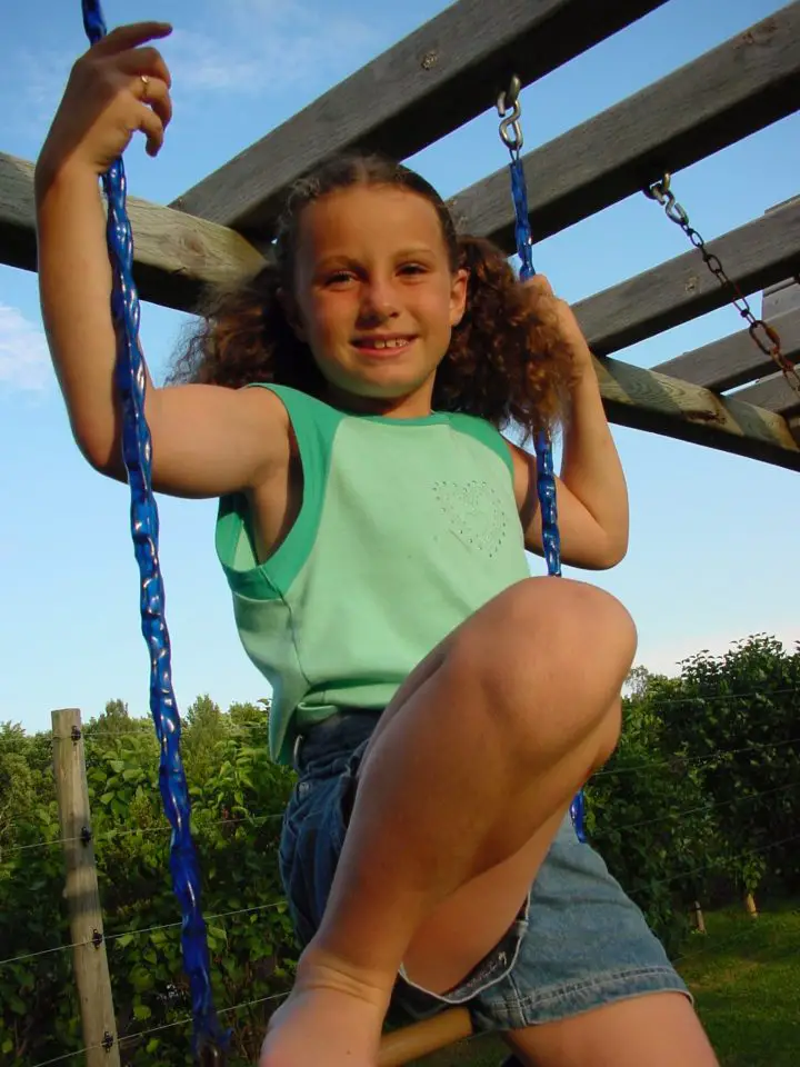 This is our Katherine, enjoying some time on a kind of trapeze. She’s a mother of four now, with kids of her own that climb and enjoy the same set she did.