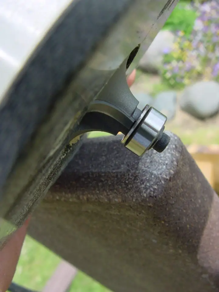 The round, shiny part of this bit is the bearing, and it rides against the edges of wood being routed. In softwood this bearing can leave an impression in the edge which is hard to remove. Use gentle pressure to avoid this problem.