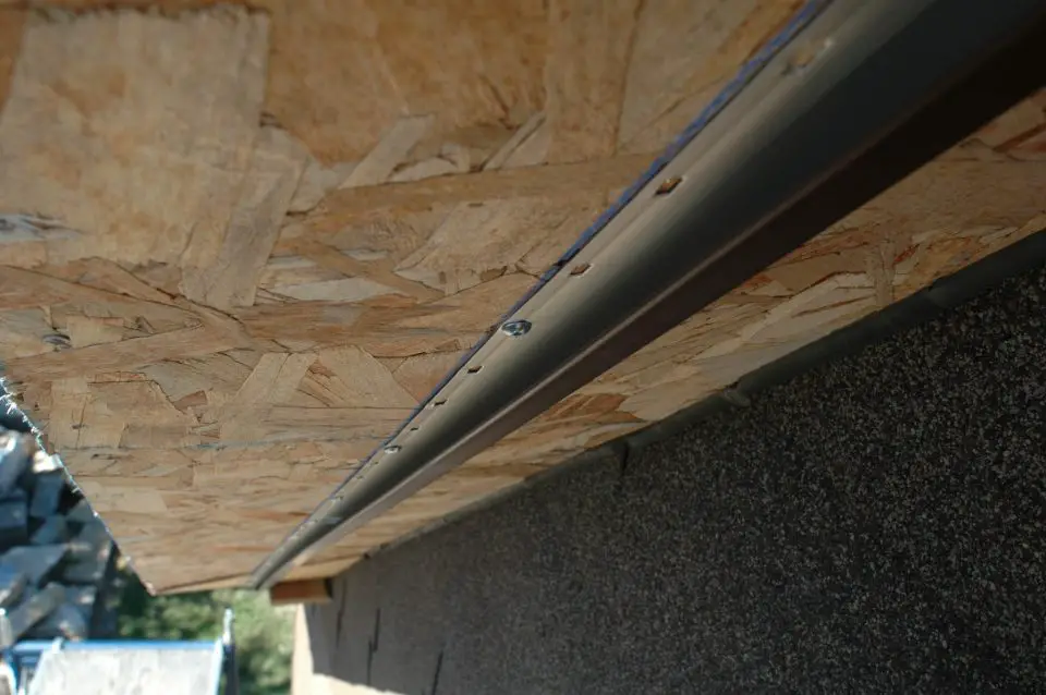 J-channel holds the back edge of aluminum soffit in place. Here it is installed under the eaves of a SIPs panel roof.
