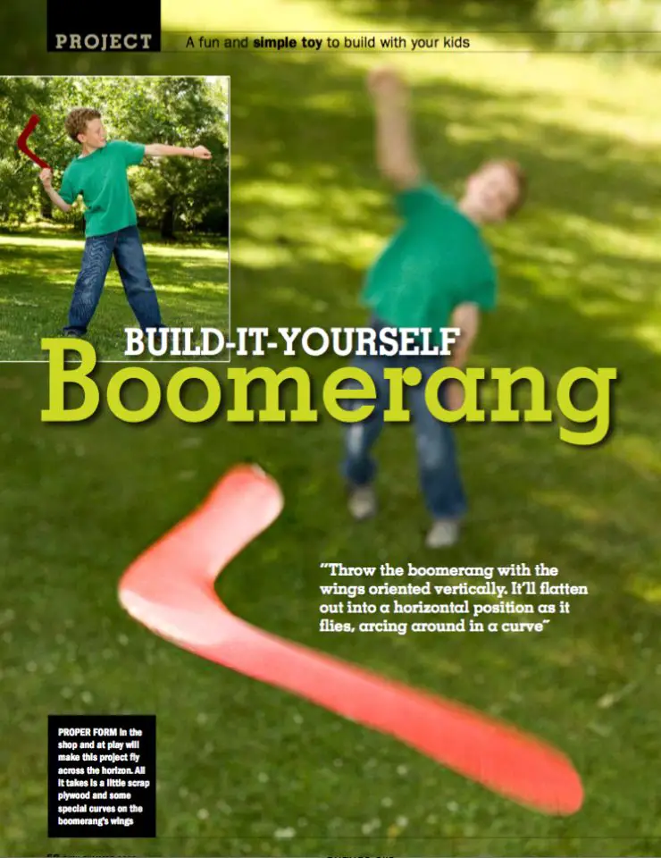 Child throws a red boomerang in park.