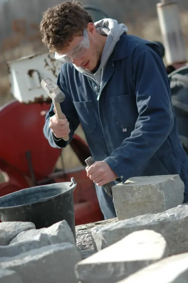 Though not a kid here, my oldest, Robert, 18 years old in this photo, chiselling stone to make foundation pillars for a cabin he began building then. He now lives in this cabin full-time with his wife and daughter, mortgage-free.