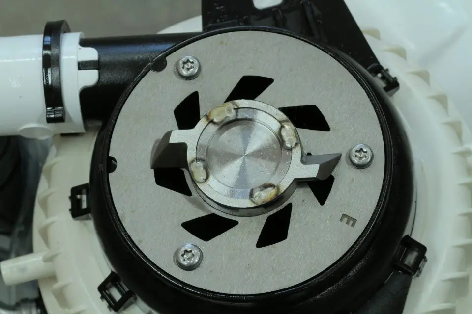 The top view of the mascerating pump, showing the revolving blade that spins and cuts up toilet “waste” so it can flow in nothing more than a 3/4″ diameter pipe.