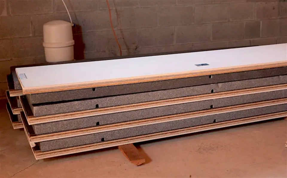 Smartwall panels piled in a basement and ready to install. This is the fastest, least skill-dependent, most mold resistant way I know of for building finished and insulated exterior basement walls.