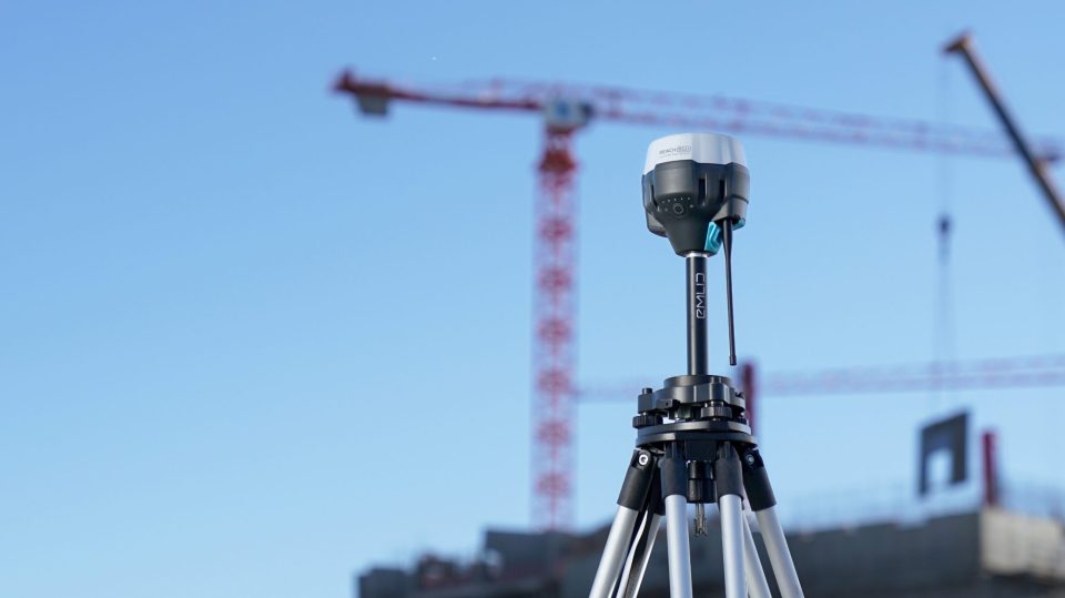 Construction site with tripod surveying equipment.