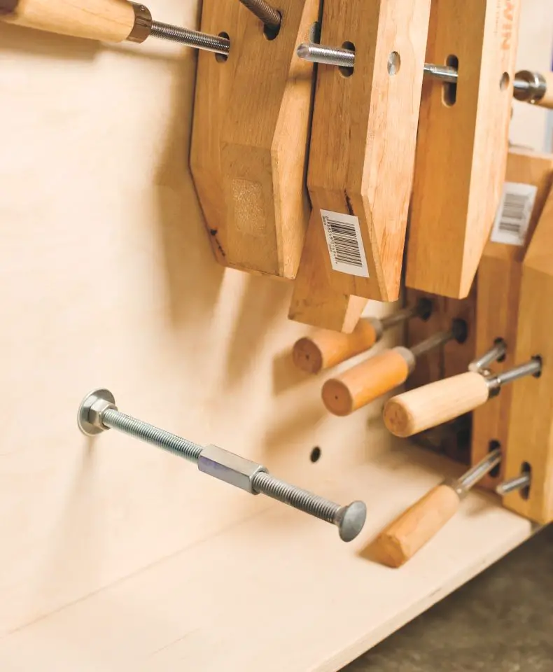 I used a threaded rod extender fitting to extend the length of carriage bolt holding my collection of wooden hand screws. A carriage gets bolted to the upright of the clamp cart, with a second carriage bolt threaded into the extender to make the whole thing longer.