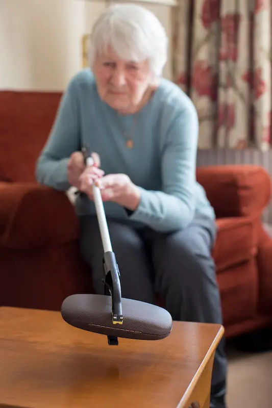 senior woman with grabbing tool