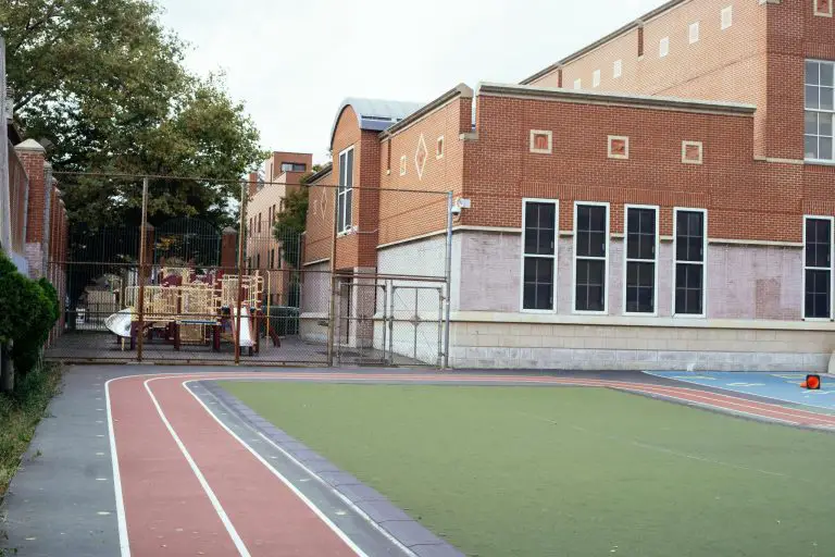 School playground with track and brick building