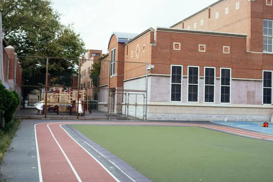 School playground with track and brick building