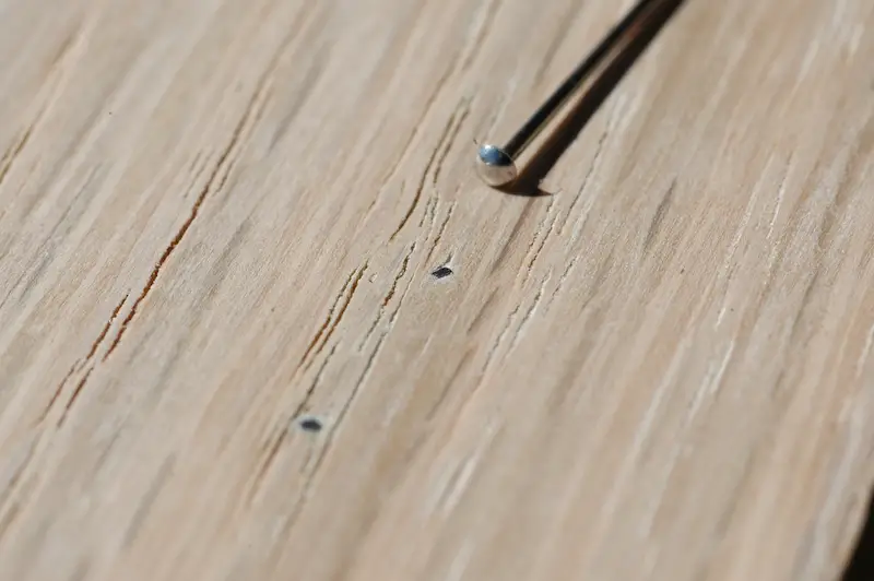 23-gauge pins are the ultimate in nearly-invisible air nailing. That’s a sewing pin up above, showing how small pins really are. Once this wood is finished, pins disappear from view almost completely.