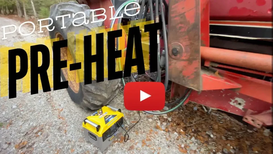 Portable engine heater beside tractor tire on gravel