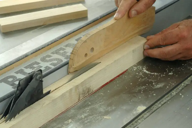 Person using table saw to cut wood.