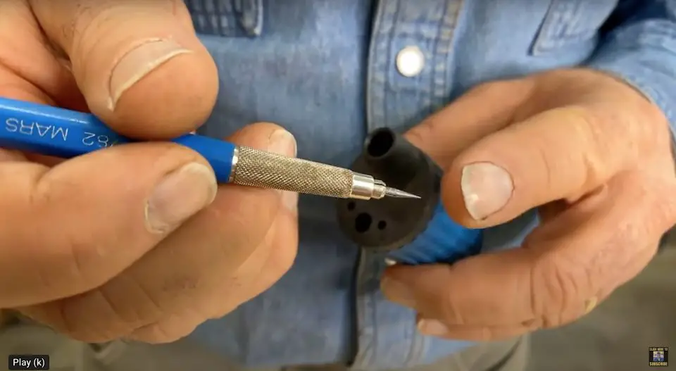 Man uses tool with pencil for measurement.