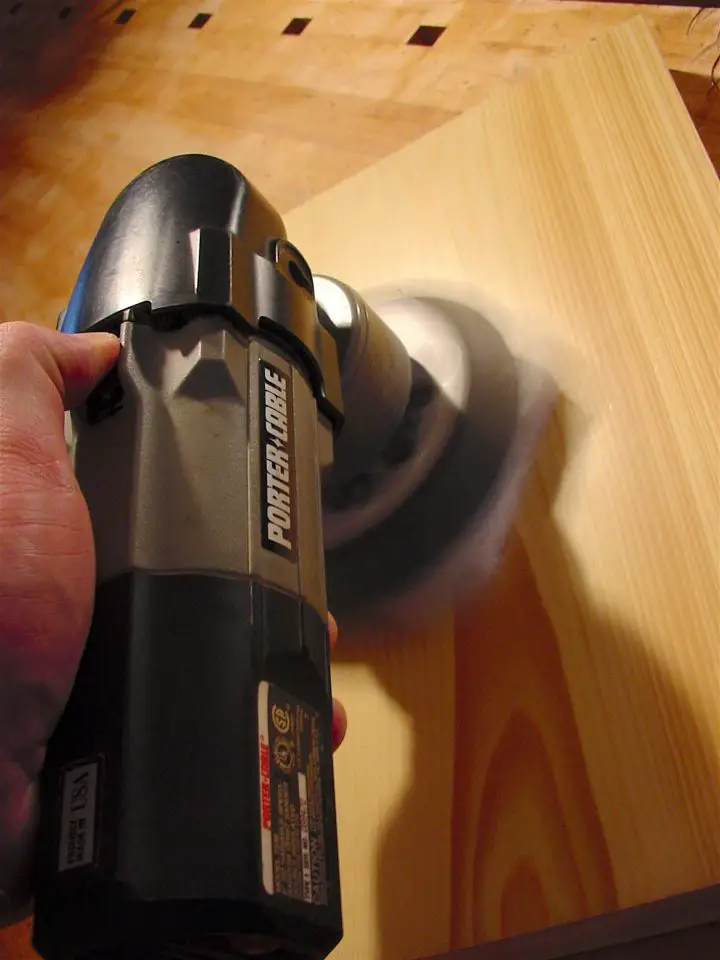 A random orbit sander with a super fine buffing pad in use perfecting a urethane finish. The results are as smooth as glass.