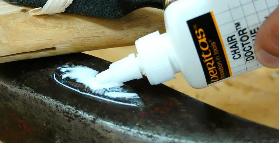 Applying glue to woodworking project with bottle
