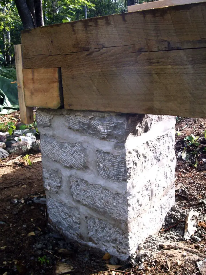 This stone foundation pier is part of the original cabin design that inspired the Cozy Cabin building course. This pier was made with local stone quarried and shaped on site, but simpler options are an option.