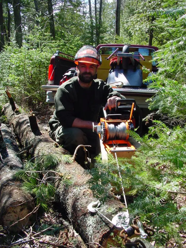 Here I am a few years back using a chainsaw-powered winch to pull logs out of the forest.