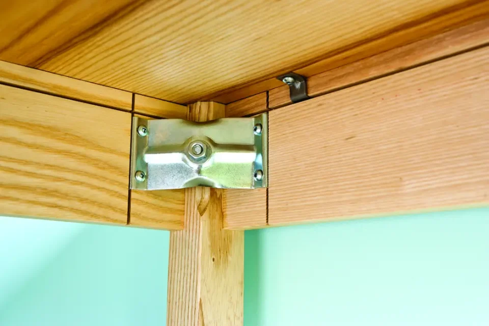 Notice the dark coloured metal clip immediately under this table top. Clips like this hold table tops firm, but also allow them to expand and contract seasonally with no issues.