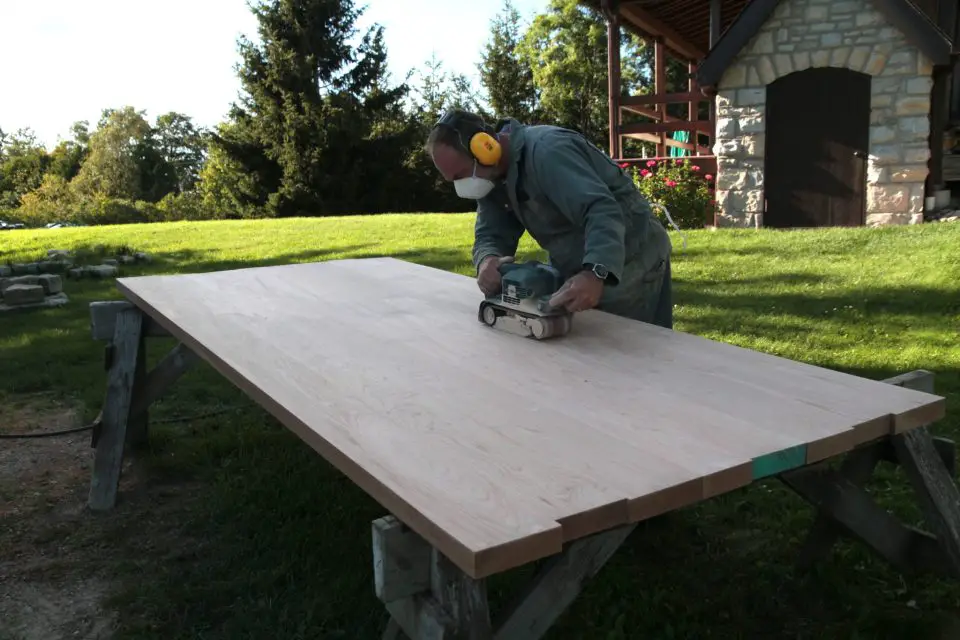 Here I am sanding a large cherry table top I made a few years ago. Sanding correctly is key to a properly finished table top, and there are many ways to do this operation improperly.
